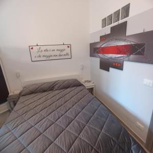 a bedroom with a bed with a sign on the wall at Casa Mole, Roma in Marino