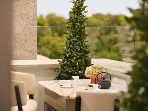 a table with a christmas tree in front of a window at 45 Park Lane - Dorchester Collection in London +44 photos