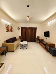 a living room with a couch and a tv at Friendz Villa in Igatpuri