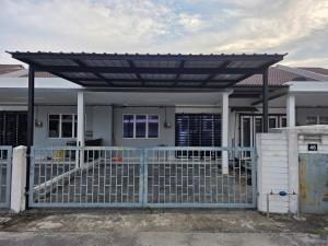 a white house with a gate and a fence at Homestay Zea in Gambang