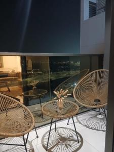 a group of chairs and tables on a balcony at Appartement Dubai in Dubai