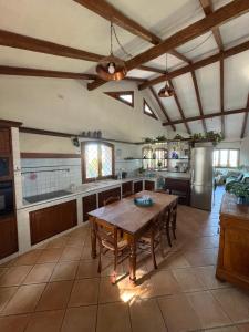 a large kitchen with a wooden table in it at Villa La Giulia in Cerveteri
