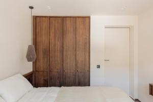 a bedroom with a wooden closet and a bed at Mountain air Legit in Palyanytsya