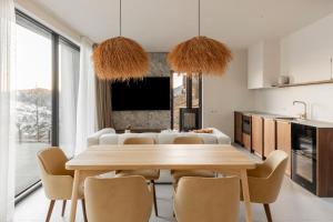 a kitchen and dining room with a table and chairs at Mountain air Legit in Palyanytsya