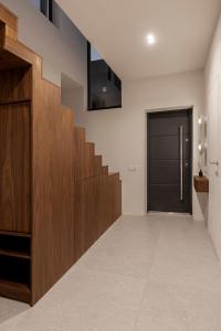 a hallway with a wooden staircase and a door at Mountain air Legit in Palyanytsya
