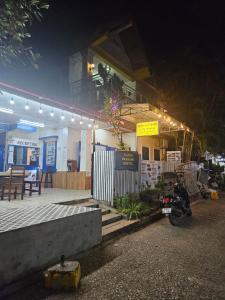 a motorcycle parked in front of a building at night at LPQ Hostel in Luang Prabang