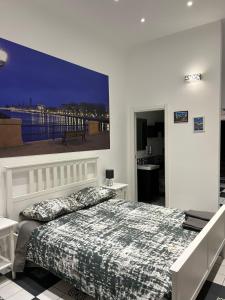 a bedroom with a bed with a large painting on the wall at Giuseppe & Greta in Bari +81 photos