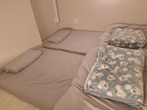 Postel nebo postele na pokoji v ubytování 専用温泉付き客室103