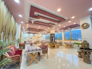 a restaurant with tables and chairs in a room at Rivana Retreat in Dehradun