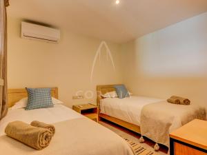 a bedroom with two beds with towels on them at Illy - Ocean by Coralia - 4 Px in Taghazout