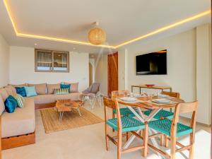 a living room with a table and a couch at Illy - Ocean by Coralia - 4 Px in Taghazout