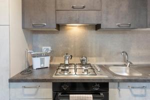a kitchen with a stove and a sink at HouSmart Montanara 606-2 in Vignola