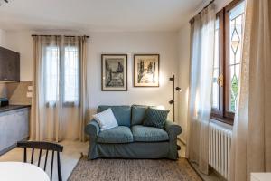 a living room with a blue couch and a window at HouSmart Montanara 606-2 in Vignola