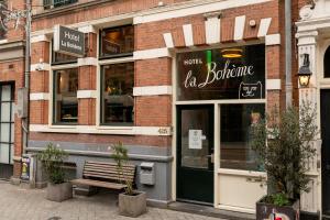 a brick building with a sign for a restaurant at Hotel La Bohème in Amsterdam