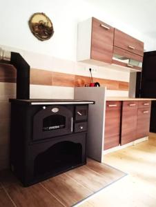 a kitchen with a black stove in the middle at Chata Bachláč, Jarabá in Jarabá