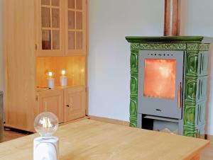a living room with a fireplace and a table at Chata Bachláč, Jarabá in Jarabá