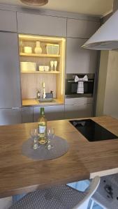 a kitchen with a table with wine glasses on it at Paradiso de Playa LaMata in La Mata