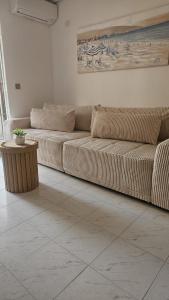 a living room with two brown couches and a table at Paradiso de Playa LaMata in La Mata