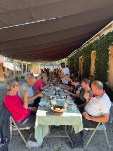 a group of people sitting at a table eating food at Nikalas Marani in Gurjaani