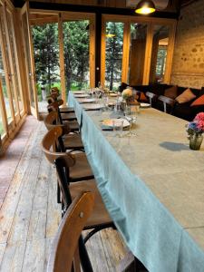 a long table with a blue table cloth on it at Nikalas Marani in Gurjaani