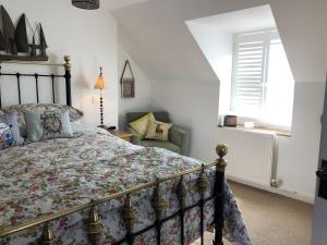 a bedroom with a bed and a chair at Sealladh Sona in Inverness