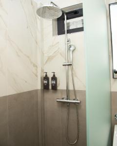 a shower in a bathroom with two bottles at Datcha Tsaghkadzor in Tsaghkadzor +34 photos