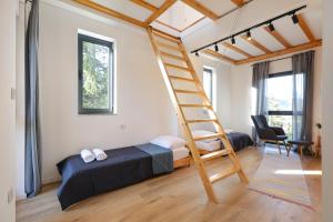 a bedroom with a bunk bed and a ladder at Viva Vlasic - Apartman i vikendica in Šišava