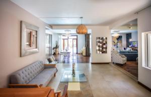 a living room with a couch and a table at Private Villa Azure Garden with pool in Grand Baie