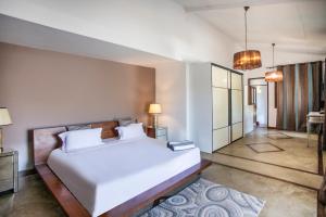 a bedroom with a large white bed in a room at Private Villa Azure Garden with pool in Grand Baie +47 photos