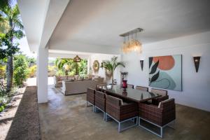 a living room with a dining table and chairs at Private Villa Azure Garden with pool in Grand Baie