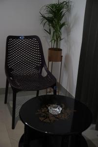 a black chair and a table with a glass bowl on it at KK Service Suites in Coimbatore