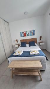a bedroom with a large bed with blue sheets at Departamento en el Centro in Puerto Madryn