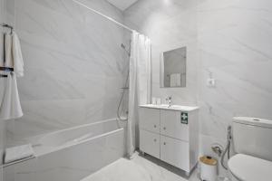 een witte badkamer met douche en wastafel bij Reis by KAAMAH in Ribeira Brava +23 foto's