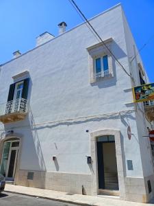 un edificio bianco con due finestre e una porta di Piano B24 a Martina Franca