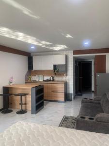 a kitchen and living room with a couch and a table at Sea Sand Sun Condominium in Ban Bang Nok