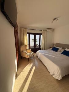 una camera con letto, sedia e televisore di CuevaBlanca a Güime Altre 18 foto