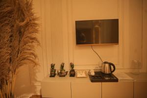 a tv on top of a dresser in a room at Meghnad By Padmaraag in Nalbāri