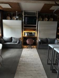a living room with two couches and a television at VIP Apart Gorlice in Gorlice