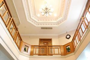 an empty hallway with a ceiling with a chandelier at FabHotel Pink Cozzy in Jaipur