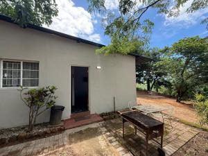 a white house with a table in front of it at Kanaan Guest Farm in Hazyview