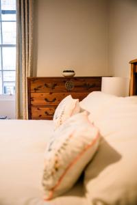 a bedroom with two pillows on a white bed at 3 Bed Traditional Apartment on Picturesque Victoria St in Edinburgh