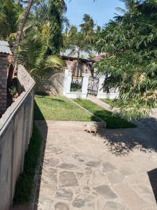 a walkway leading to a yard with a fence at majaoni villa in Mombasa