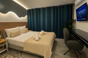 a bedroom with a bed with two towels on it at Concept Rooms in Costa de Adeje