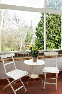 two chairs and a table in front of a window at SPACIOUS Apartment in London