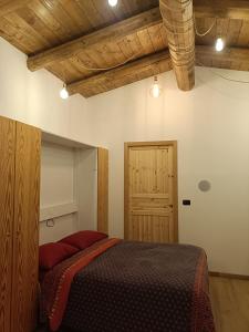 une chambre avec un lit et une porte en bois dans l'établissement la casa sull'arcobaleno 1, à Manta