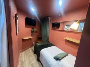 a small room with a bed and a tv at Hotel Comédie - Place De La Comédie Opéra in Montpellier