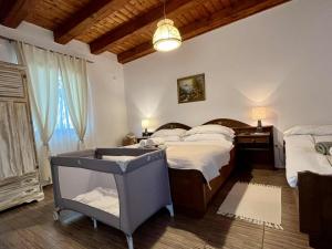 a bedroom with two beds and a large window at Hármaspuszta Vendégház in Fülöpszállás
