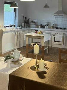 a kitchen with a table with two candles on it at Hármaspuszta Vendégház in Fülöpszállás