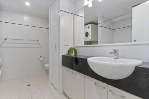 een witte badkamer met een wastafel en een toilet bij Cityscape on Mounts Bay in Perth +23 foto's