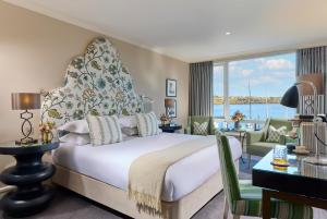 a bedroom with a bed and a view of the ocean at Trident Hotel Kinsale in Kinsale